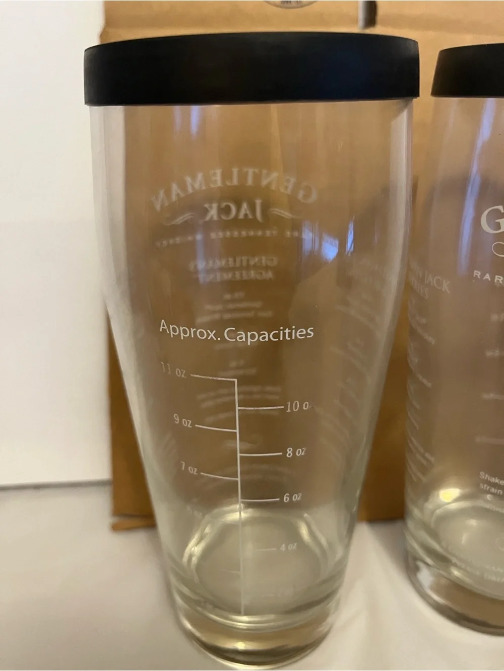 2,Gentleman Jack brand glass cocktail shaker with a recipe printed on the side.